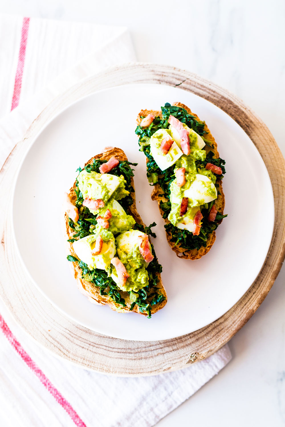 Toast is an ultra comforting food, and these yummy tostadas feature egg, bacon, avocado, and kale on crisp wholegrain toasts. https://www.spotebi.com/recipes/egg-bacon-avocado-tostadas/