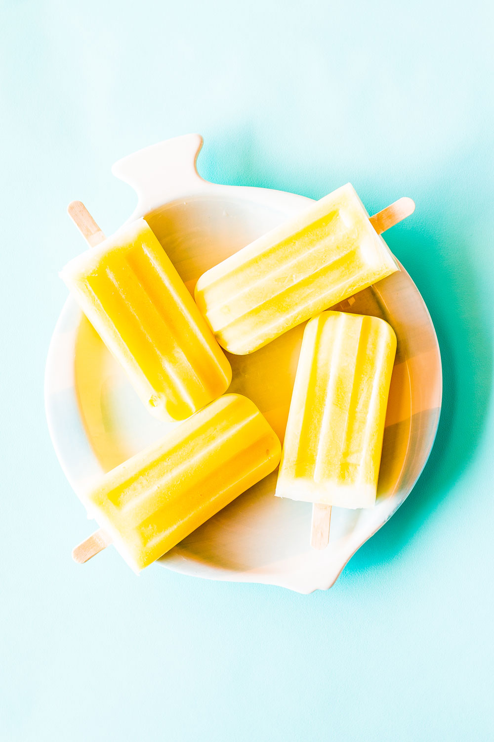 For this Healthy 3-Ingredient Orange & Mango Popsicles recipe, we mixed chunks of mango with blended orange juice, mango, and yogurt and topped each popsicle with plain velvety yogurt! https://www.spotebi.com/recipes/healthy-3-ingredient-orange-mango-popsicles/