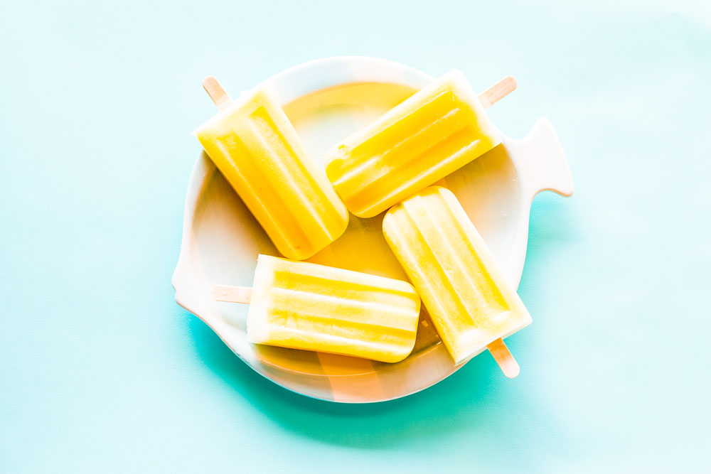 For this Healthy 3-Ingredient Orange & Mango Popsicles recipe, we mixed chunks of mango with blended orange juice, mango, and yogurt and topped each popsicle with plain velvety yogurt! https://www.spotebi.com/recipes/healthy-3-ingredient-orange-mango-popsicles/